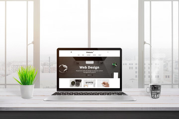 Wall Mural - laptop with creative, flat web site desing presentation. plant and cup of coffee on white wooden des