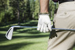© Mint Images - Closeup of hands and golf club.