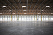 © Mint Images - Wide angle interior view of large empty warehouse and loading dock doors