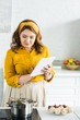 © LIGHTFIELD STUDIOS - beautiful woman using tablet in kitchen