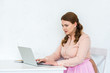 © LIGHTFIELD STUDIOS - side view of beautiful woman using laptop at kitchen