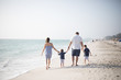 © MeganMahoneyPhotos - Family with Young Boys Holding Hands and Walking Down the Coastline at the Beach