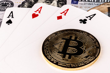 Bitcoin on a four of a kind poker hand and 100 dollar bill representing the gamble of digital Cryptocurrency XII