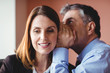 © Wavebreak Media - Businessman and businesswoman gossiping