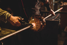 Glassblower Holding Blowpipe With Diamond Shears