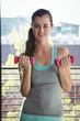 © Wavebreak Media - Portrait of woman lifting dumbbell