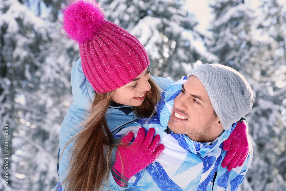 Happy couple at snowy countryside. Winter vacation