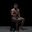© honored - Young muscular man with dumbbell