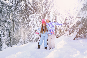 Canvas Print - Happy couple having fun in snowy countryside. Winter vacation