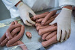 © Wavebreak Media - Butcher packing raw sausages in meat factory