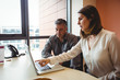 © Wavebreak Media - Woman discussing with colleague over laptop