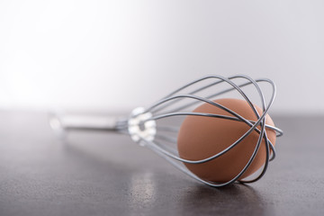 Brown egg trapped in whisk