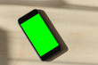 Smartphone blank screen wooden background top view