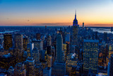 Fototapeta Nowy Jork - New York City skyline at night - skyscrapers of midtown Manhattan with Empire State Building at Amazing Sunset - USA