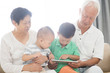 © WONG SZE FEI - Grandparents and grandchildren using tablet pc