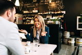 Fototapeta  - Smiling blonde businesswoman enjoying on a first date.