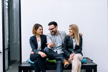 Wall Mural - Three business people having fun, talking.