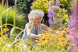 © Kzenon - Portrait of a blond senior woman with an active lifestyle enjoying retirement during work in the garden in a sunny day of summer