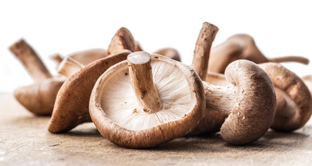 Shiitake mushrooms on the wooden background.