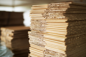 Wall Mural - Close up picture of stacks of folded brown cardboard.