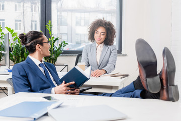 Wall Mural - African american businessman and woman discussing ideas in office