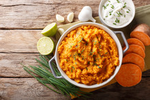 Freshly Prepared Mashed Sweet Potatoes With Herbs, Garlic And Lime Close Up In A Pot. Horizontal Top View