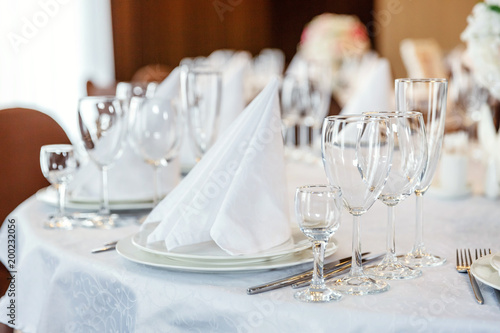 Glasses Flowers Fork Knife Napkin Folded In A Pyramid Served