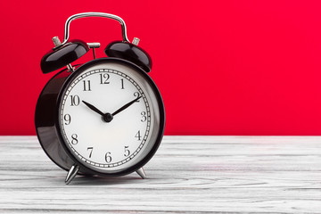 alarm clock wooden plank colored background