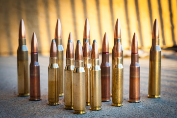 Various types and sizes of rifle Ammunition of arranged in triangle formation