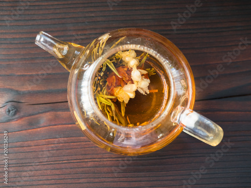 Fototapeta na drzwi i meble exotic green tea with flowers in glass teapot