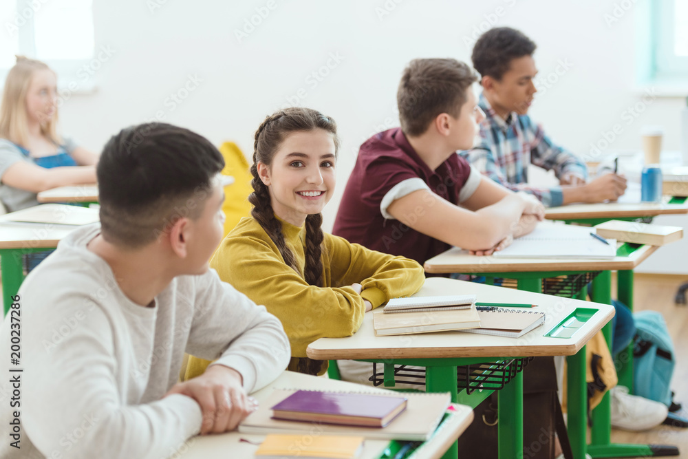 row of high school students sitting in class during lesson - obrazy, fototapety, plakaty 