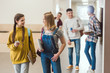 © LIGHTFIELD STUDIOS - high school classmates walking by school corridor together