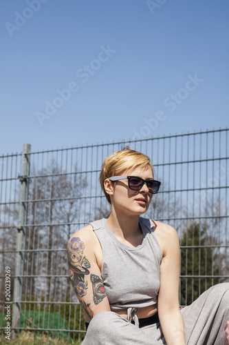 Natural Looking Woman With Blonde Short Hair And Tattoo Wearing