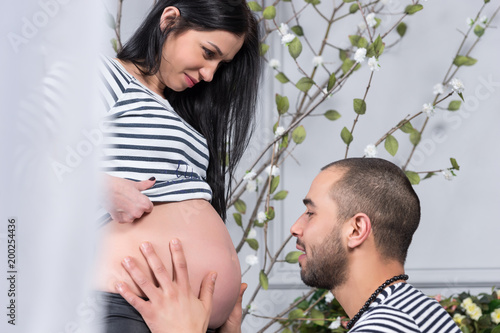 Beautiful International Couple Muslim Man Sat Down Opposite And Holding The Belly Of His Pregnant Wife Buy This Stock Photo And Explore Similar Images At Adobe Stock Adobe Stock
