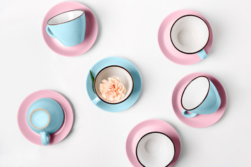 Wall Mural - Elegant porcelain blue and pink cups on abstract background