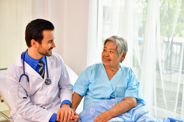 Wall Mural - Concept of healing care, The doctor is healing  old woman.