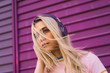 © Kike Arnaiz/ADDICTIVE STOCK - Young woman with purple headphones