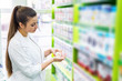 © RomanR - Chemist looking at tablets in her palm