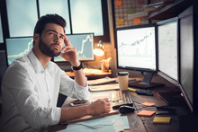 Businessman Thinking And Using Computer Of Trading Graph