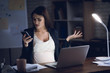 © freeograph - Beautiful pregnant girl is upset because of phone call. Upset pregnant girl in office alone.
