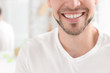 © New Africa - Young man with beautiful smile indoors. Teeth whitening