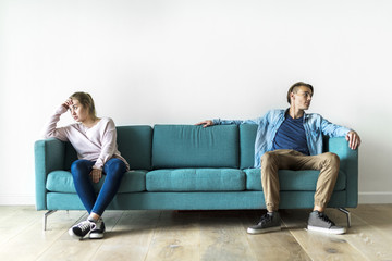 Wall Mural - Couple moody sitting on sofa