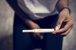 © Rawpixel.com - Closeup of black woman with pregnancy test in a hand