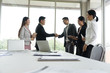 © anon - Business people shaking hands, finishing up a meeting in the office.