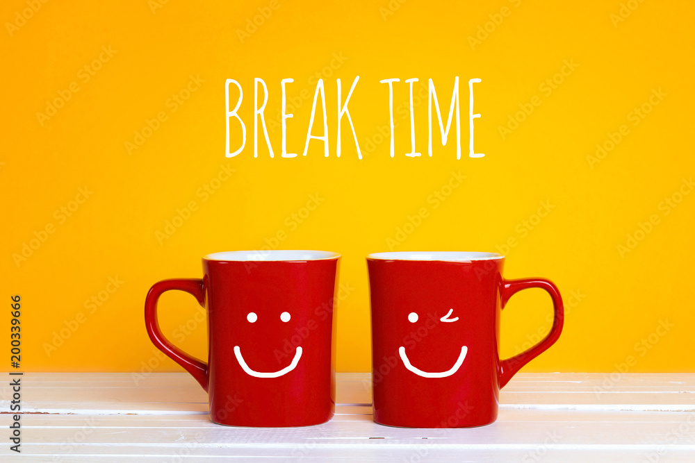 Two red coffee mugs with a smiling faces on a yellow background with ...