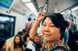 © pongmoji - Asian woman travel on skytrain train in city