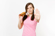 © ViDi Studio - Young strict woman showing stop gesture with palm, holding in hands burger isolated on white background. Proper nutrition or American classic fast food. Copy space for advertisement. Advertising area.