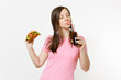 © ViDi Studio - Beautiful fun young woman with tails standing and holding burger, cola in glass bottle isolated on white background. Proper nutrition or American classic fast food. Advertising area with copy space.