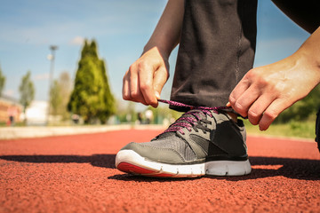  Close up image women tying  sport shoes.