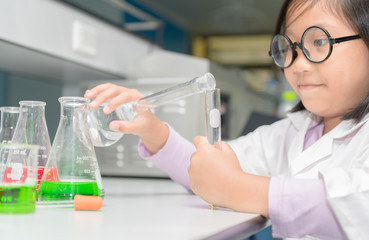 Wall Mural - happy scientist girl making experiment with test tube